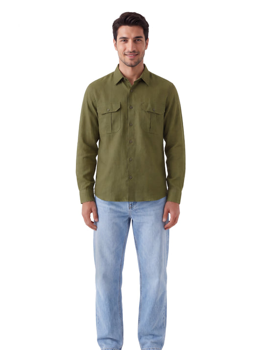 A man wearing an olive green long-sleeve button-up shirt with two chest pockets and light blue jeans, standing against a plain white background.