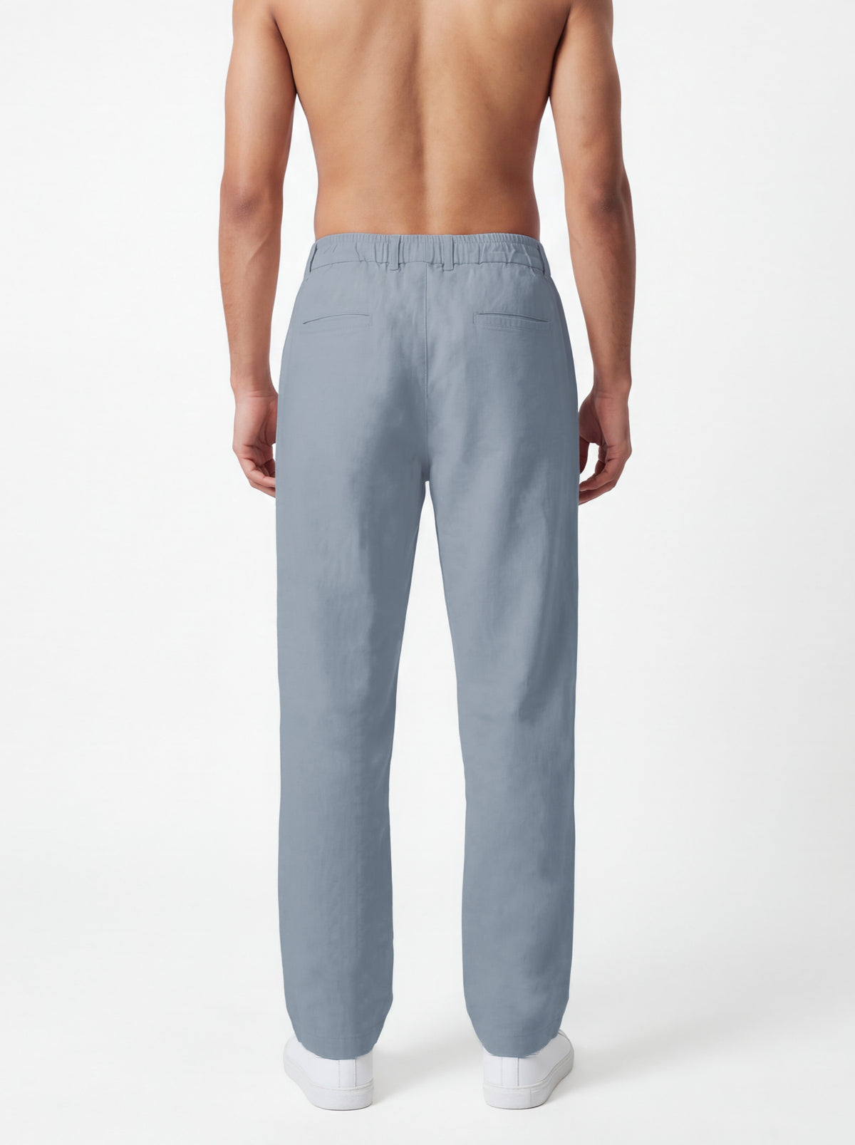A man shown from the back wearing light blue straight-leg trousers, photographed against a clean white studio background.