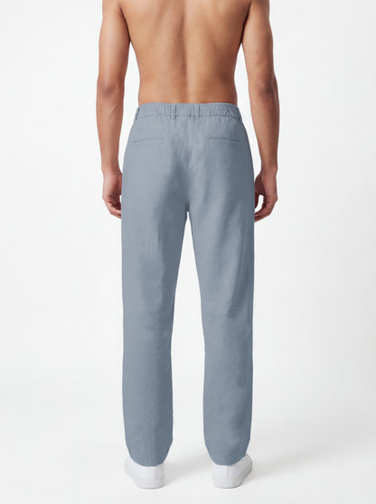 A man shown from the back wearing light blue straight-leg trousers, photographed against a clean white studio background.