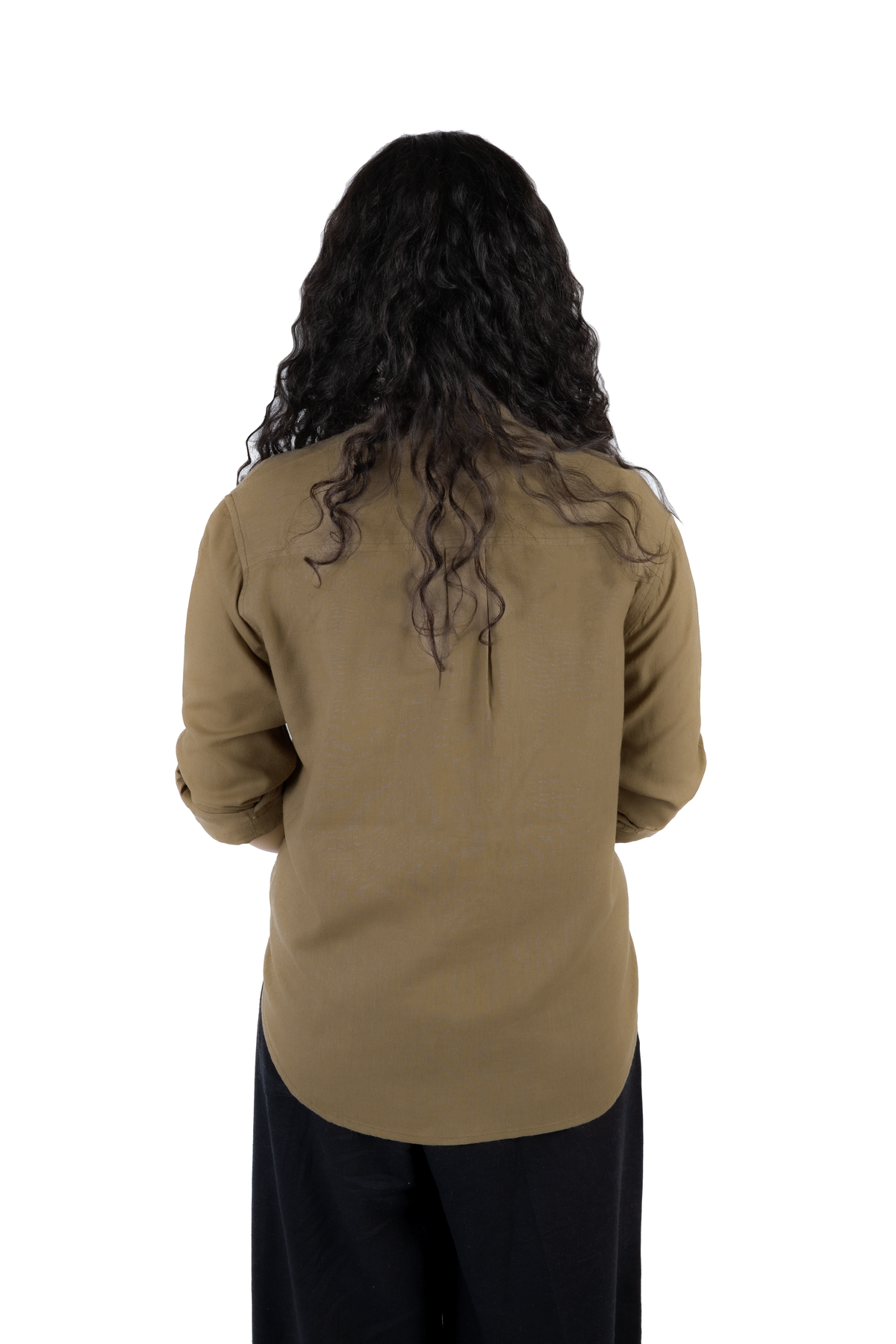 A person viewed from the back wearing a long-sleeve olive-brown top and dark pants against a plain white background.