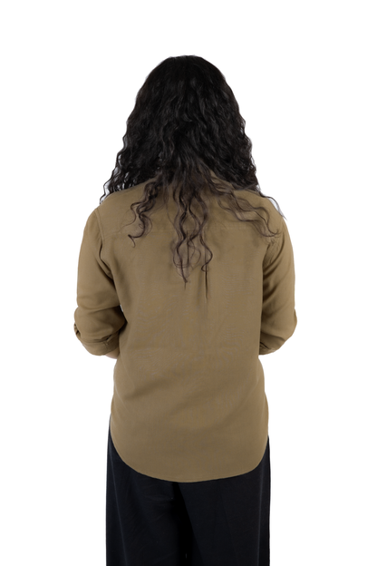 A person viewed from the back wearing a long-sleeve olive-brown top and dark pants against a plain white background.
