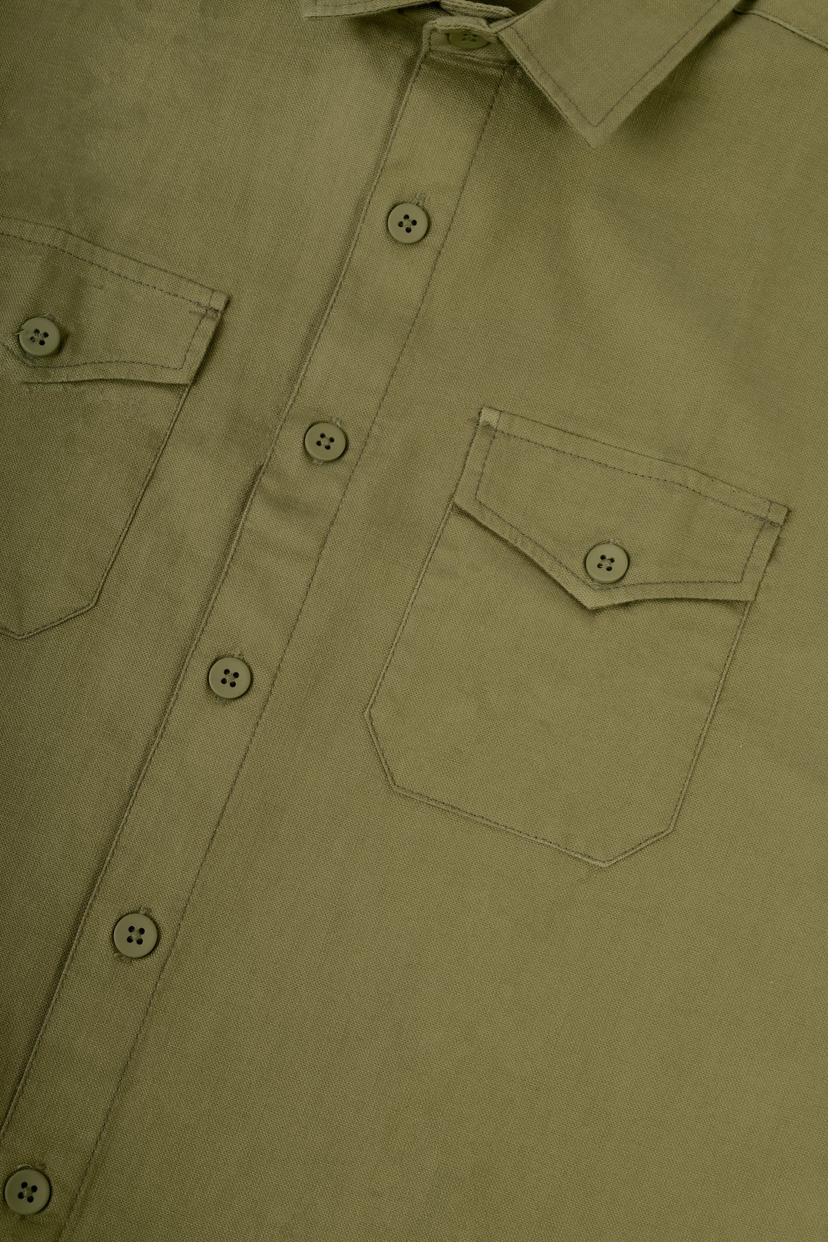 Close-up of an olive green button-down shirt showing the chest pocket, button closure, and collar.