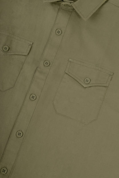 Close-up of a button-front shirt with two chest pockets and a pointed collar in a muted olive-tan color.