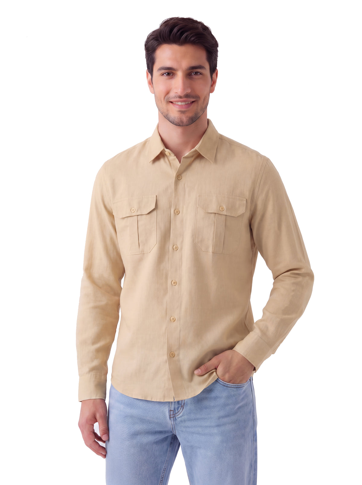 A man wearing a light beige long-sleeve button-up shirt with two chest pockets and light blue jeans, standing against a plain white background.