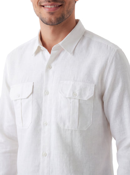 A close-up of a man wearing a white long-sleeve linen button-up shirt with two buttoned chest pockets, shown against a plain white background.