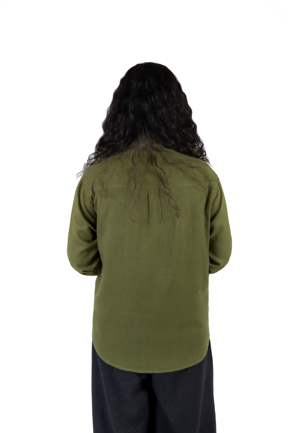 A person viewed from the back wearing an olive green long-sleeve shirt and dark pants, standing against a plain white background.