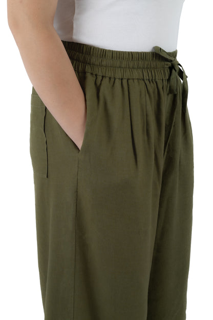 Olive green wide-leg trousers with an elastic drawstring waistband and side pockets, shown on a model wearing a white top against a white background.