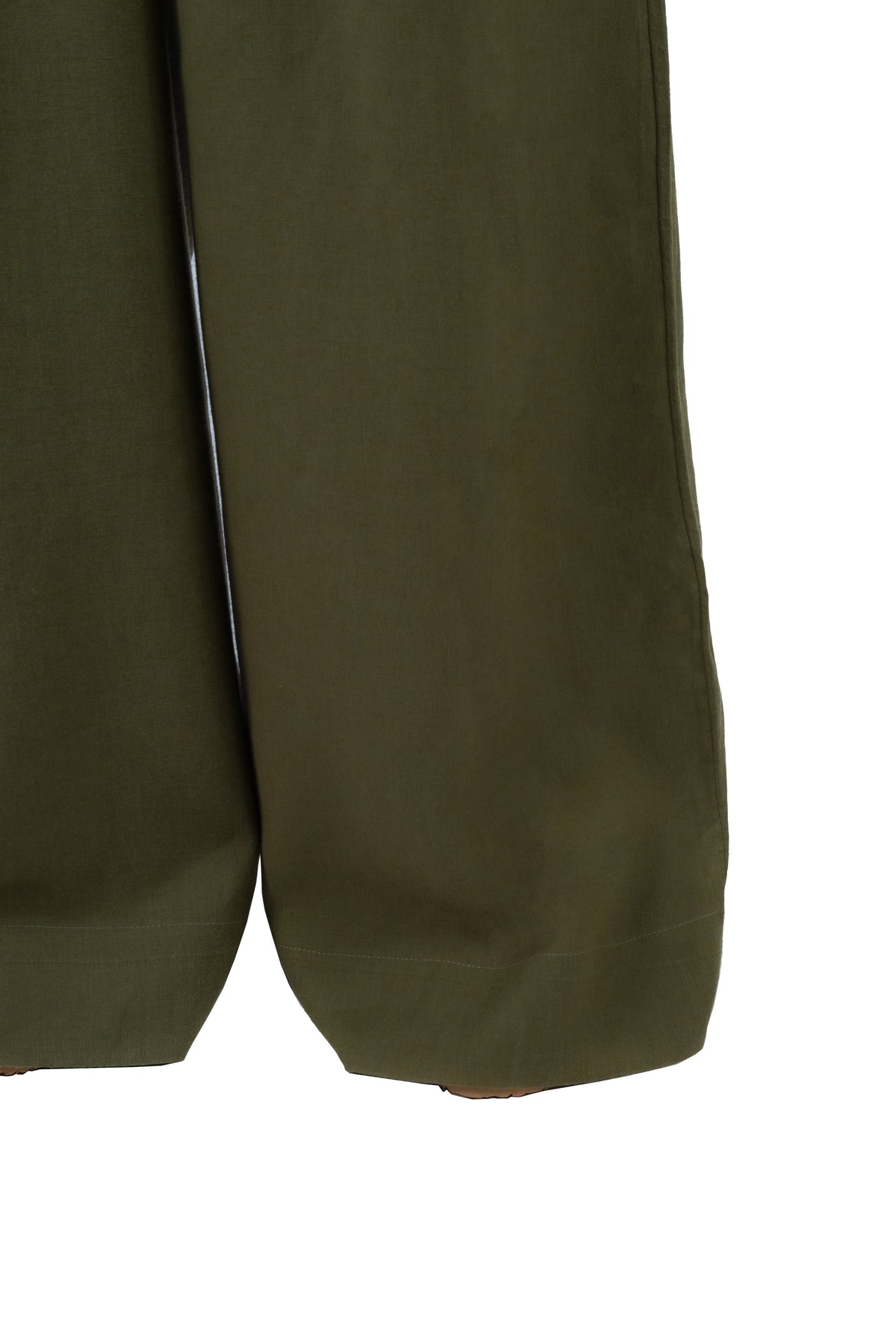 Close-up of olive green trousers showing the fabric texture and hem detail against a white background.