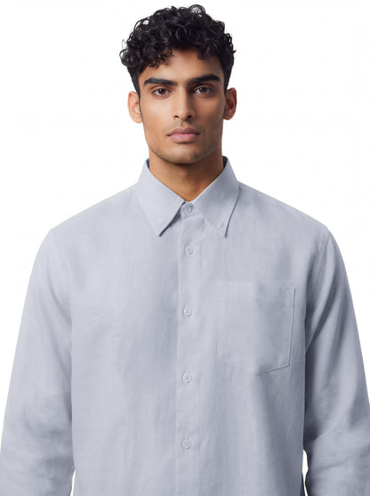 A man wearing a light gray long-sleeve button-down shirt with a chest pocket, photographed against a plain white background.