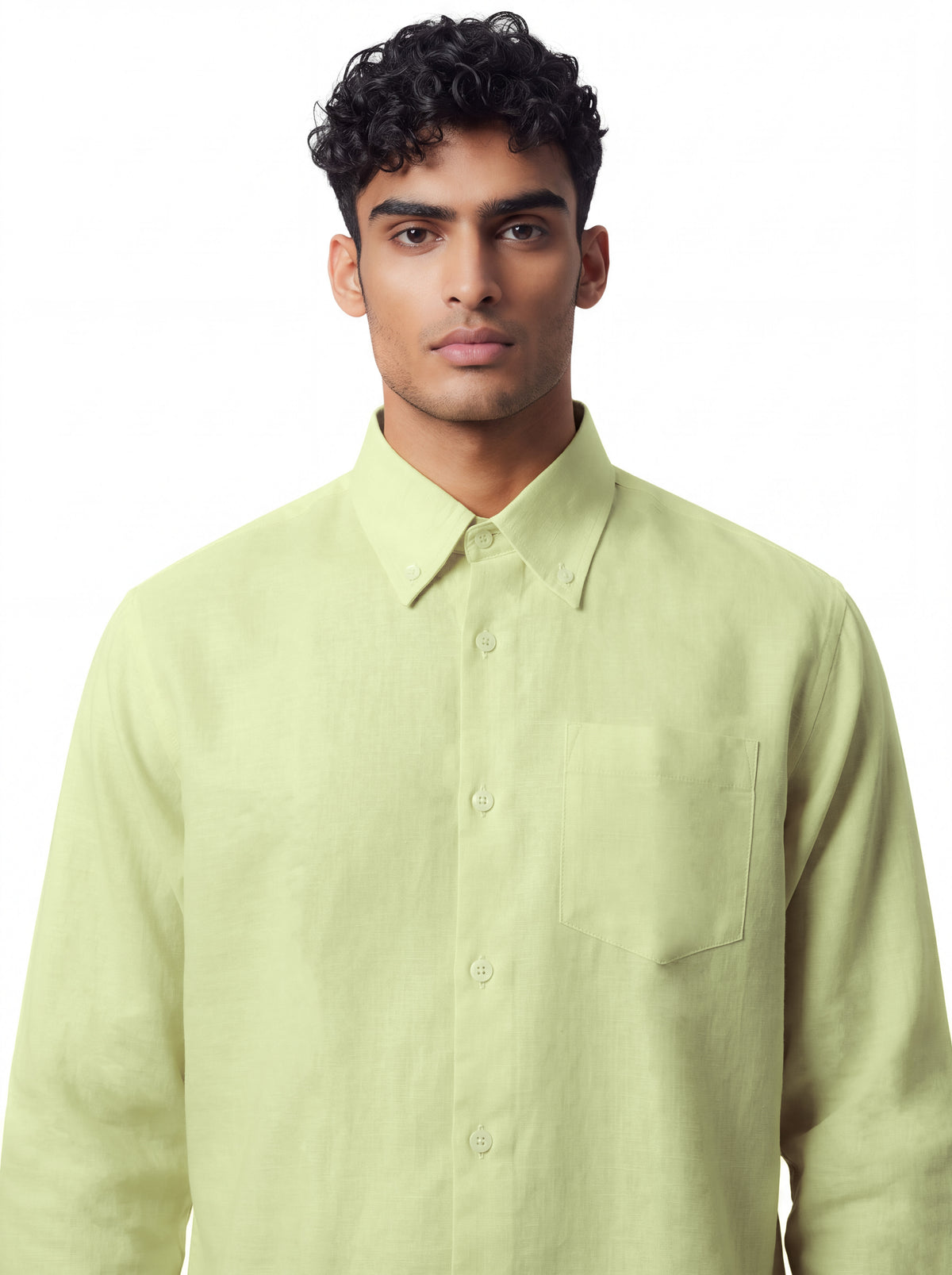 A man wearing a light yellow-green long-sleeve button-down shirt with a chest pocket, photographed against a plain white background.
