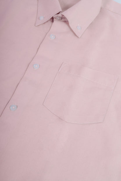 A closeup of a pastel pink  button-down shirt.