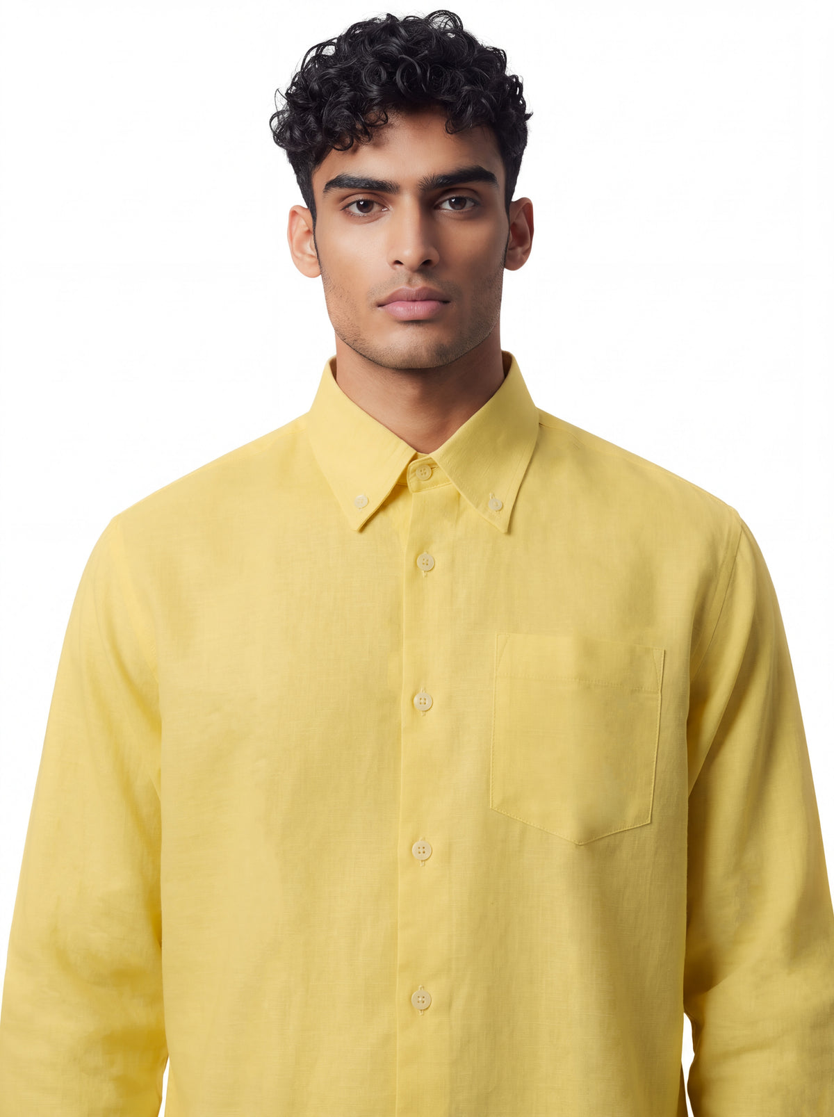 A man wearing a light yellow long-sleeve button-down shirt with a chest pocket, photographed against a plain white background.